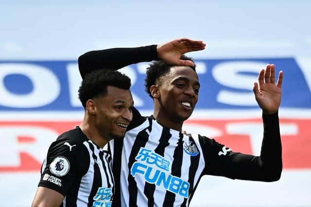 Joe Willock celebrates his goal with Jacob Murphy, left.