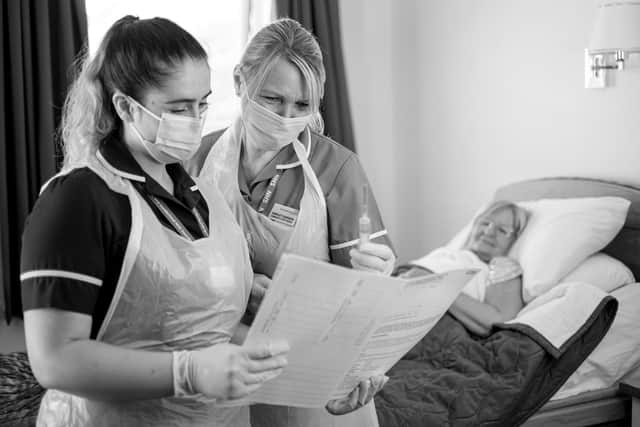 Community nurses providing support to a patient.
