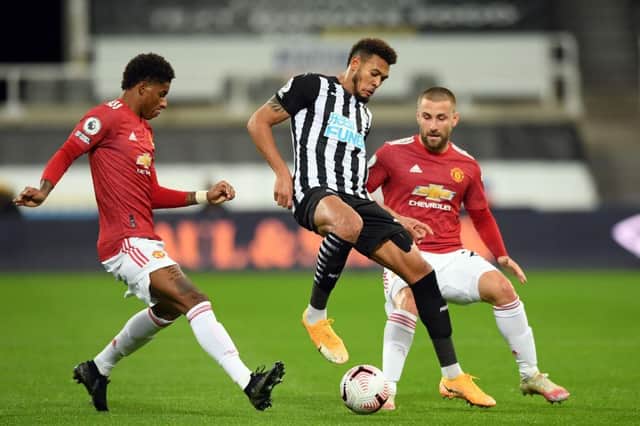 Manchester United's English striker Marcus Rashford (L) and Manchester United's English defender Luke Shaw (R) close in on Newcastle United's Brazilian striker Joelinton during the English Premier League football match between Newcastle United and Manchester United at St James' Park in Newcastle-upon-Tyne, north east England on October 17, 2020.