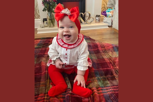 Mabel Mackie, age 7 months, ready to celebrate her first Christmas.