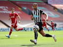Callum Wilson of Newcastle United looks to control the ball during the Premier League match between Liverpool and Newcastle United at Anfield on April 24, 2021 in Liverpool, England.
