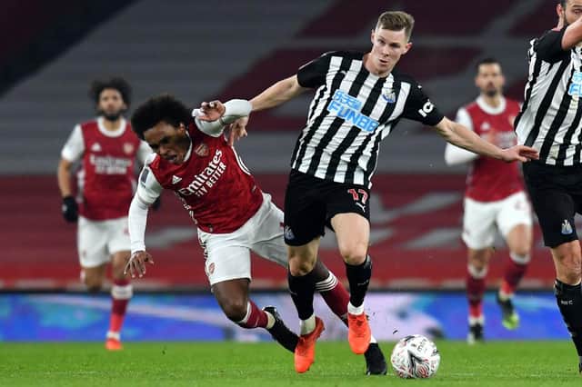 Arsenal's Brazilian midfielder Willian (L) vies with Newcastle United's Swedish defender Emil Krafth (C) during the English FA Cup third round football match between Arsenal and Newcastle United at the Emirates Stadium in London on January 9, 2021.