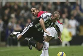 Newcastle United legend Alan Shearer playing against Manchester United's Rio Ferdinand in 2004. (Photo by Alex Livesey/Getty Images)