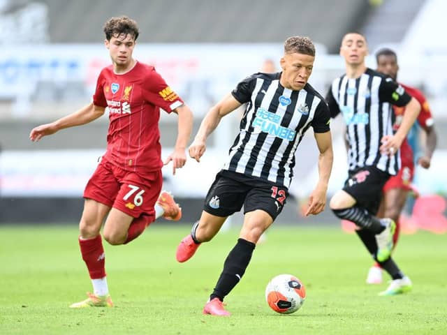 Dwight Gayle of Newcastle United gets away from Neco Williams of Liverpool during the Premier League match between Newcastle United and Liverpool FC at St. James Park on July 26, 2020 in Newcastle upon Tyne, England.