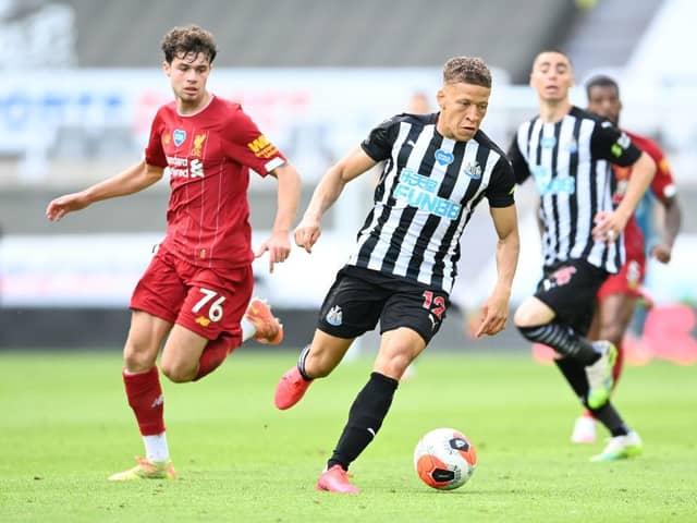 Dwight Gayle of Newcastle United gets away from Neco Williams of Liverpool during the Premier League match between Newcastle United and Liverpool FC at St. James Park on July 26, 2020 in Newcastle upon Tyne, England.
