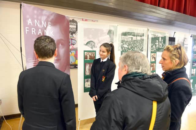 Pupils taking groups of parents on a tour of the Holocaust exhibition.