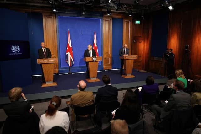 Prime Minister Boris Johnson, accompanied by England's Chief Medical Officer for England Chris Whitty, left, and Chief Scientific Adviser Patrick Vallance at a press conference where Plan B restrictions were announced. Picture: Getty Images.