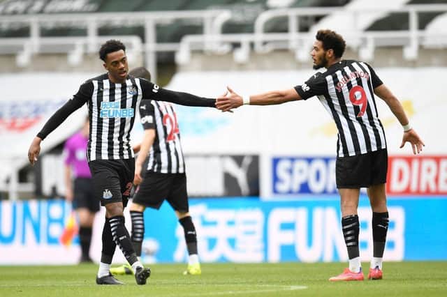 Newcastle United's English midfielder Joe Willock (L) celebrates scoring his team's second goal with Newcastle United's Brazilian striker Joelinton (R) during the English Premier League football match between Newcastle United and Tottenham Hotspur at St James' Park in Newcastle-upon-Tyne, north east England on April 4, 2021.