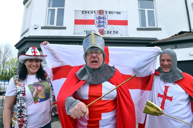 Dougie's Tavern manager Norman Scott, centre, gets ready for St George's Day with Emma Scott and Bobby Park.