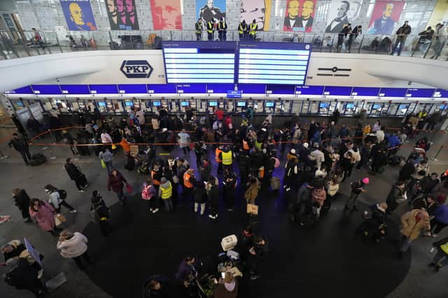 People, some who have fled Ukraine, line up at a ticket counter at the train station in Warsaw, Poland, March 13, 2022. (AP Photo/Czarek Sokolowski, File)