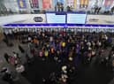 People, some who have fled Ukraine, line up at a ticket counter at the train station in Warsaw, Poland, March 13, 2022. (AP Photo/Czarek Sokolowski, File)