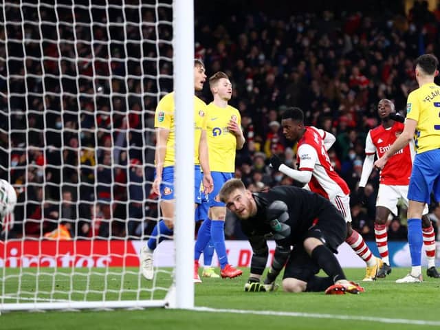 Eddie Nketiah of Arsenal scores their team's fourth goal and his hat-trick past Lee Burge of Sunderland. (Photo by Ryan Pierse/Getty Images)