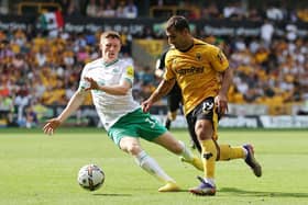 Newcastle United's Elliot Anderson challenges Jonny of Wolverhampton Wanderers.