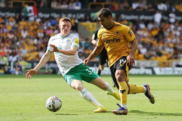 Newcastle United's Elliot Anderson challenges Jonny of Wolverhampton Wanderers.