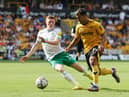 Newcastle United's Elliot Anderson challenges Jonny of Wolverhampton Wanderers.