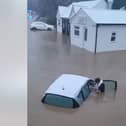 Woman is pulled from car during heroic flood rescue