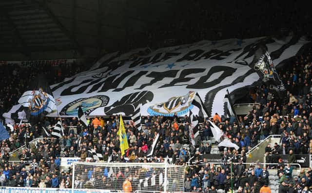 NEWCASTLE UPON TYNE, ENGLAND - MARCH 31:  Fans of Newcastle United unvail a giant flag in the stand during the Premier League match between Newcastle United and Huddersfield Town at St. James Park on March 31, 2018 in Newcastle upon Tyne, England.  (Photo by Tony Marshall/Getty Images)