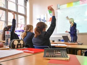 A teacher and students in a classroom. Image: PA
