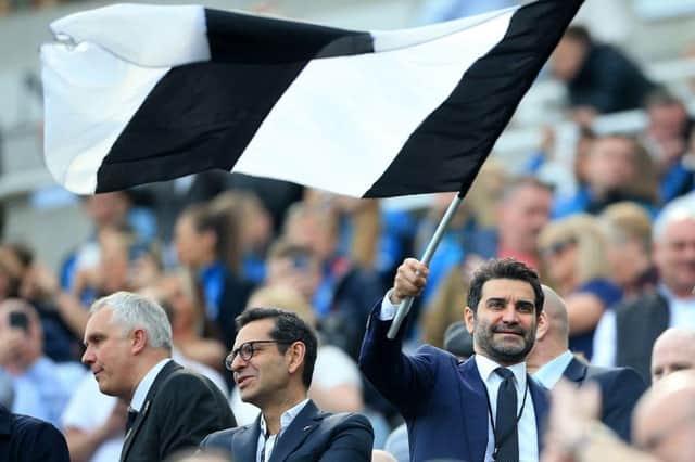 Mehrdad Ghodoussi, husband of Newcastle United's English minority owner Amanda Staveley waves a flag in the crowd ahead of the English Premier League football match between Newcastle United and Leicester City at St James' Park in Newcastle-upon-Tyne, north east England on April 17, 2022.  (Photo by LINDSEY PARNABY/AFP via Getty Images)