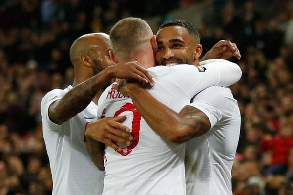 England's striker Callum Wilson (R) celebrates scoring their third goal with England's striker Wayne Rooney (C) and England's midfielder Fabian Delph (L) during the international friendly football match between England and the United States at Wembley stadium in north London on November 15, 2018.