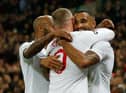 England's striker Callum Wilson (R) celebrates scoring their third goal with England's striker Wayne Rooney (C) and England's midfielder Fabian Delph (L) during the international friendly football match between England and the United States at Wembley stadium in north London on November 15, 2018.