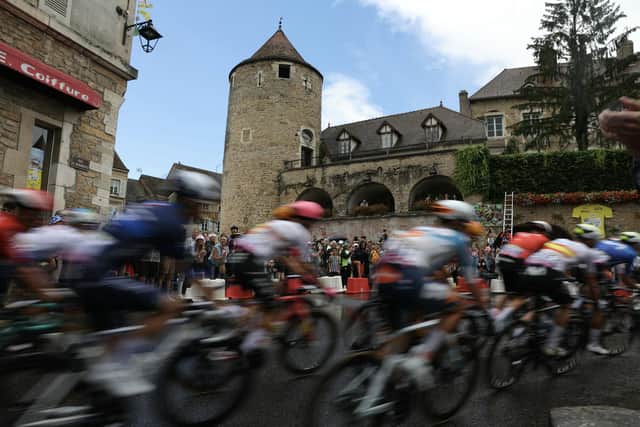 The riders in this year's Tour de France cycle through the town of Buxy, in Burgundy, one of the sights you can see on Eurosport's coverage of the event (Picture: THOMAS SAMSON/AFP via Getty Images)