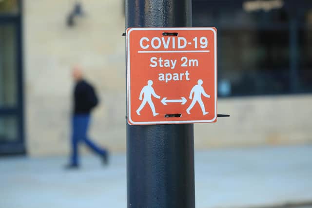 A sign advising people to stay two metres apart on a lamppost in the centre of Bradford, West Yorkshire, one of the areas where new measures have been implemented to prevent the spread of coronavirus. Picture: PA.