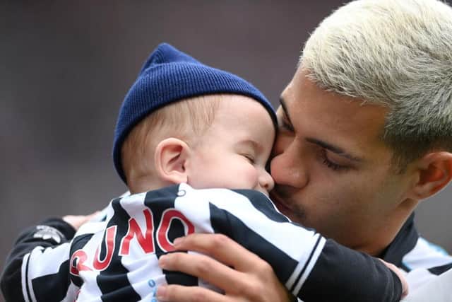 Newcastle player Bruno Guimaraes pictured with his child before the Premier League match between Newcastle United and Southampton FC at St. James Park on April 30, 2023 in Newcastle upon Tyne, England. (Photo by Stu Forster/Getty Images)