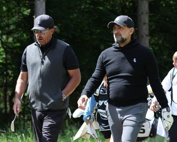 Golfer Phil Mickelson, centre, and Newcastle United chairman Yasir Al-Rumayyan, right, walk as they take part in the Pro-Am round of the LIV Golf Invitational Series event at The Centurion Club in St Albans.