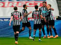 Newcastle United's English striker Dwight Gayle (R) celebrates with teammates after scoring their second goal during the English Premier League football match between Newcastle United and West Bromwich Albion at St James' Park in Newcastle-upon-Tyne, north east England on December 12, 2020.