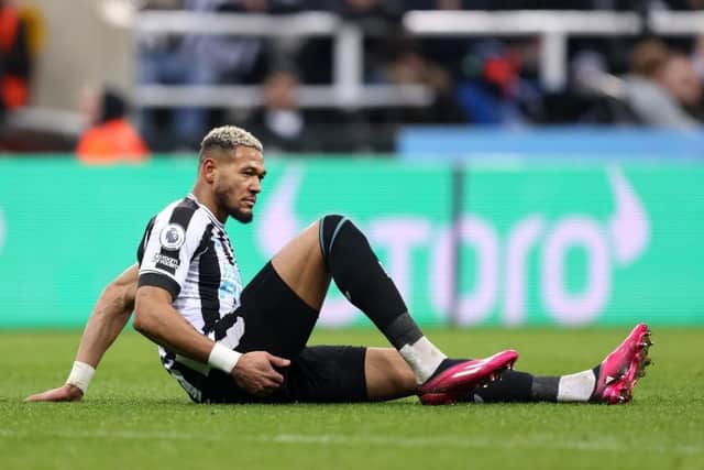 Joelinton down needing treatment during Newcastle United's home defeat to Liverpool.