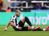 Joelinton down needing treatment during Newcastle United's home defeat to Liverpool.
