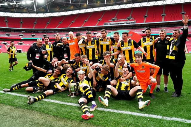 Hebburn Town players and staff celebrate with the Buildbase FA Vase 2019/20 Trophy after the Final at Wembley Stadium, London.