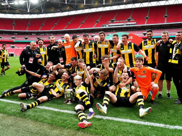 Hebburn Town players and staff celebrate with the Buildbase FA Vase 2019/20 Trophy after the Final at Wembley Stadium, London.