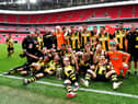 Hebburn Town players and staff celebrate with the Buildbase FA Vase 2019/20 Trophy after the Final at Wembley Stadium, London.