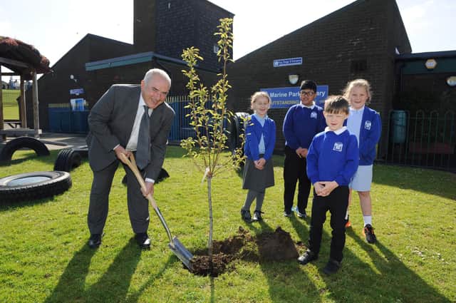 South Tyneside Council Cllr Ernest Gibson helps Marine Park Primary School year 2 pupils, Teddy Humphreys, Saiful Islam, Scarlett Graham, and Alice Cooke, plant a fruit tree in the school grounds.