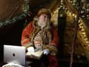 Father Christmas learns how to use Zoom on a laptop in the grotto at Bamburgh castle in Northumberland,