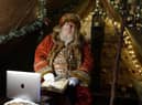 Father Christmas learns how to use Zoom on a laptop in the grotto at Bamburgh castle in Northumberland,