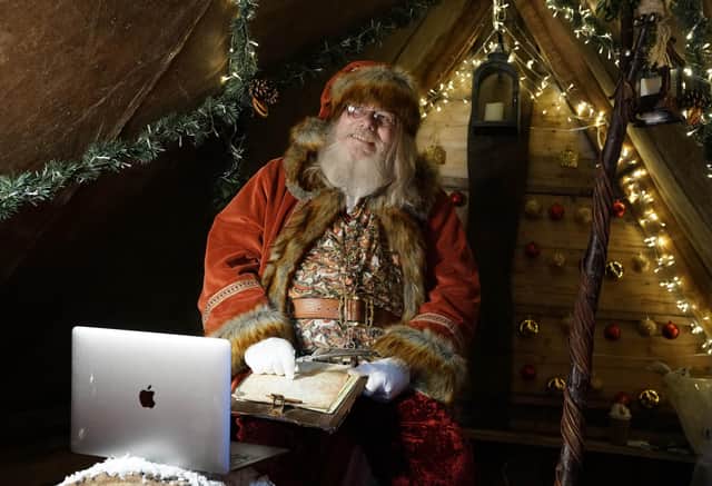 Father Christmas learns how to use Zoom on a laptop in the grotto at Bamburgh castle in Northumberland,