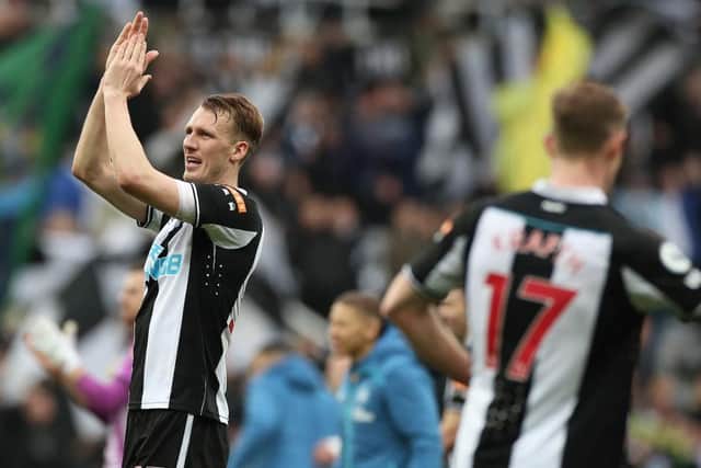 Dan Burn of Newcastle United celebrates with fans after their sides victory the Premier League match between Newcastle United and Brighton & Hove Albion at St. James Park on March 05, 2022 in Newcastle upon Tyne, England. (Photo by Ian MacNicol/Getty Images)