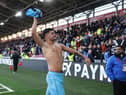 Bruno Guimaraes throws his shirt to fans at Brentford last weekend.