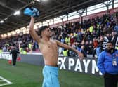 Bruno Guimaraes throws his shirt to fans at Brentford last weekend.