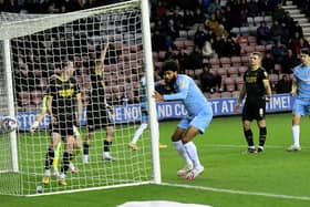 Ellis Simms scores at the DW Stadium earlier this season