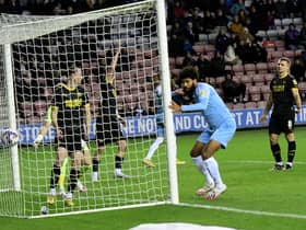 Ellis Simms scores at the DW Stadium earlier this season