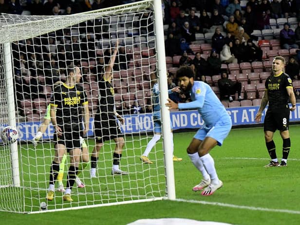 Ellis Simms scores at the DW Stadium earlier this season