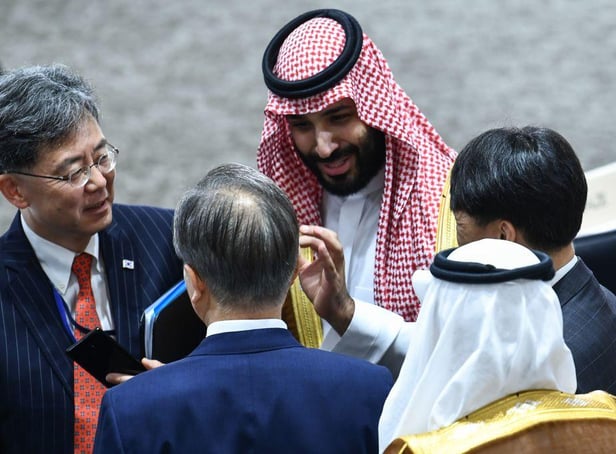 Saudi Arabia's Crown Prince Mohammed bin Salman (top) speaks with South Korea's President Moon Jae-in (C) during session 3 on women's workforce participation, future of work, and ageing societies during the G20 Summit in Osaka on June 29, 2019.