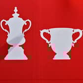 League Cup trophy (R) and FA Cup trophy (L).(Photo by Oli SCARFF / AFP) (Photo by OLI SCARFF/AFP via Getty Images)