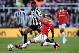 Newcastle United's Swedish striker Alexander Isak (L) vies with Manchester United's Argentinian defender Lisandro Martinez (R) during the English Premier League football match between Newcastle United and Manchester United at St James' Park in Newcastle-upon-Tyne, north east England on April 2, 2023. (Photo by Oli SCARFF / AFP) /