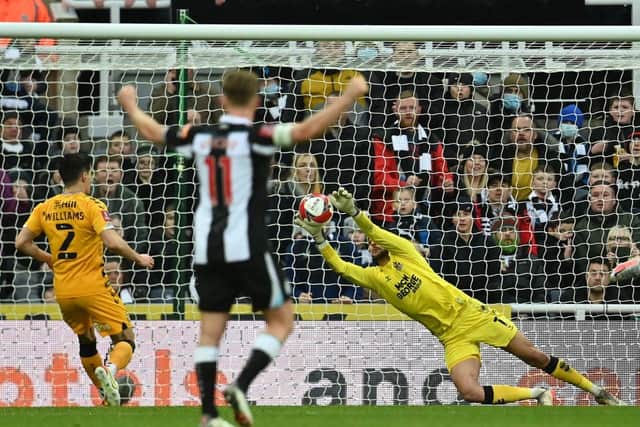 Cambridge United's Bulgarian goalkeeper Dimitar Mitov makes a save during the English FA Cup third round football match between Newcastle United and Cambridge United at St James' Park in Newcastle-upon-Tyne, north east England on January 8, 2022 (Photo by PAUL ELLIS/AFP via Getty Images)
