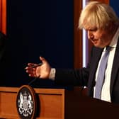 Prime Minister Boris Johnson gestures whilst speaking at a press conference in London's Downing Street after ministers met to consider imposing new restrictions in response to rising cases and the spread of the Omicron variant. Picture date: Wednesday December 8, 2021.